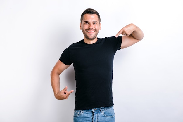 Portrait of egoistic arrogant selfish man with beard pointing at himself, boasting successful achievement, feeling proud and supercilious. Indoor studio shot, white background