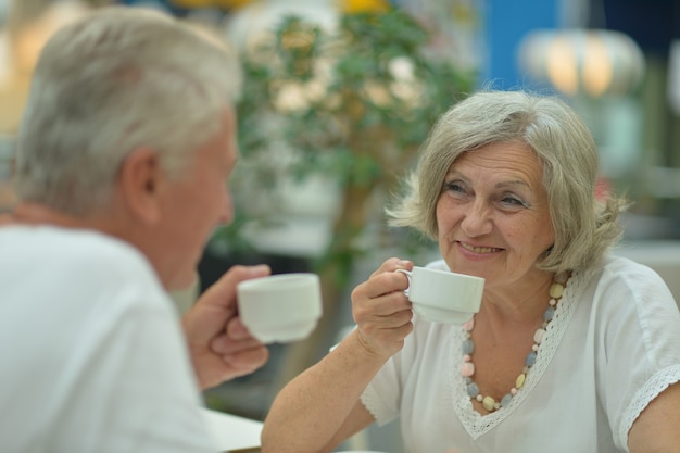 Portrait of an elderly couple on date drinking coffee