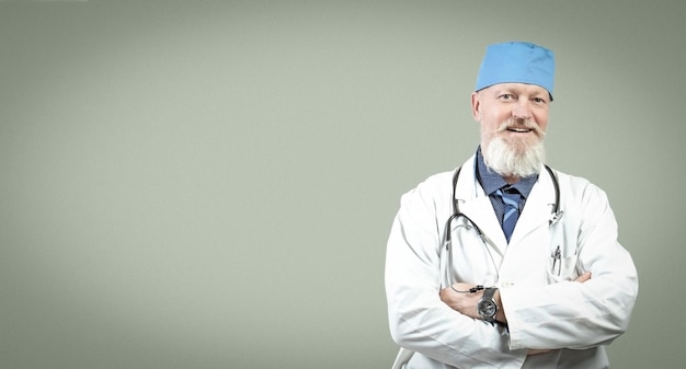 Portrait of an elderly graybearded positive doctor with a stethoscope