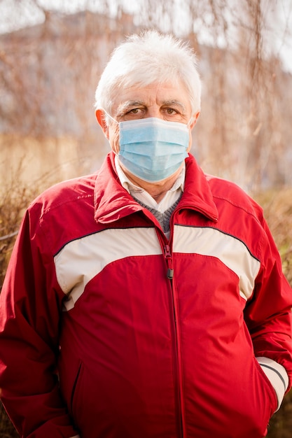 Portrait of an elderly man in a protective mask