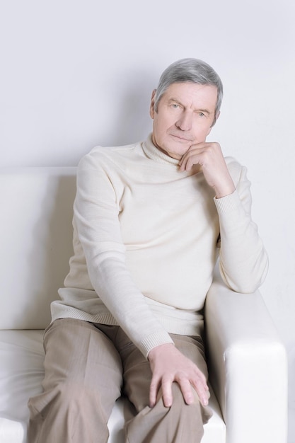 Portrait of an elderly man sitting in a chair