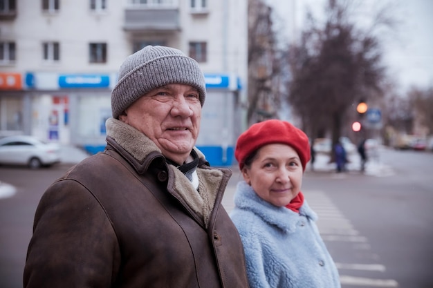 Portrait of elderly man with mature wife on winter city street