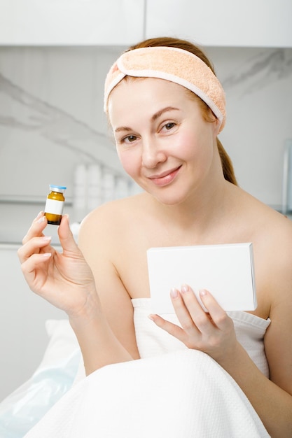 Portrait of an elderly woman in a beauty salon He holds a cosmetic product in his hand