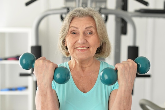 Portrait of elderly woman exercising in gym