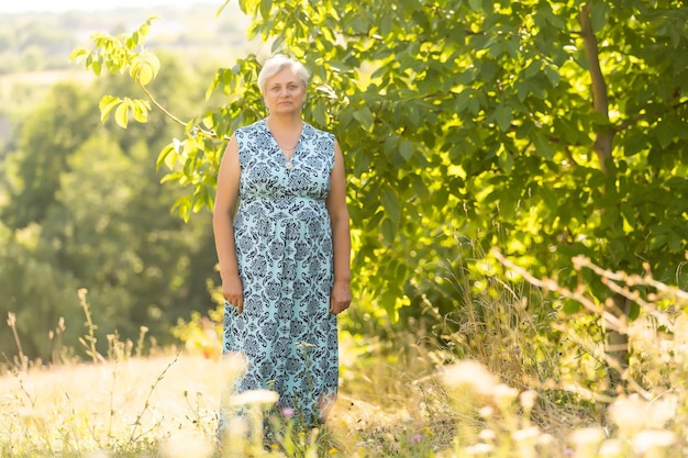 Portrait of the elderly woman. A photo on outdoors