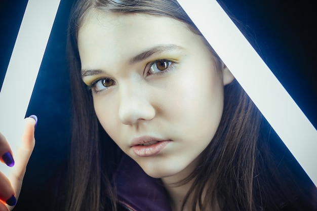 Portrait of elegant beautiful woman posing with glowing neon lights