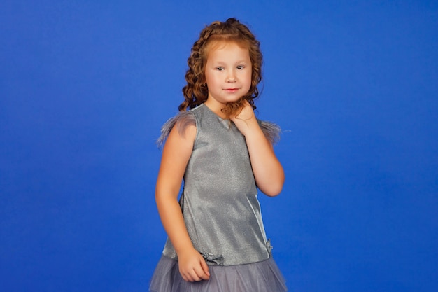 Portrait of an elegant cute seven-year-old girl in festive stylish clothes