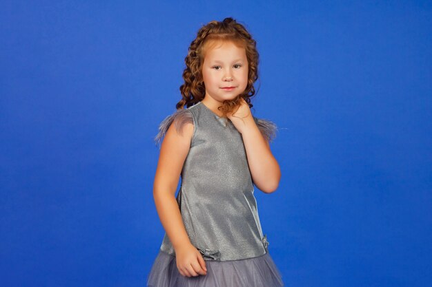 Portrait of an elegant cute seven-year-old girl in festive stylish clothes