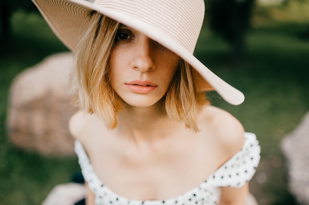 Portrait of elegant stylish blonde short hair girl in hat posing