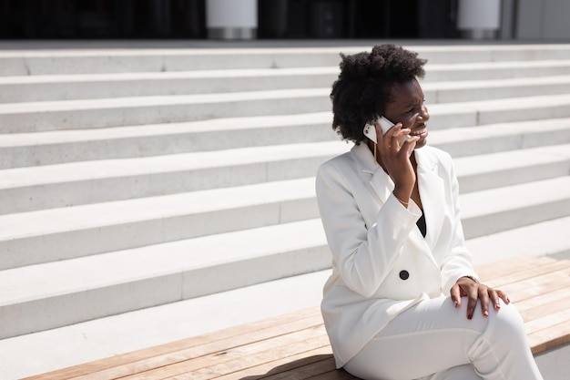 portrait of elegant successful african woman with mobile phone