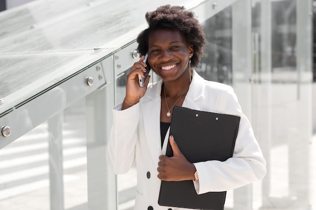 portrait of elegant successful african woman with mobile phone