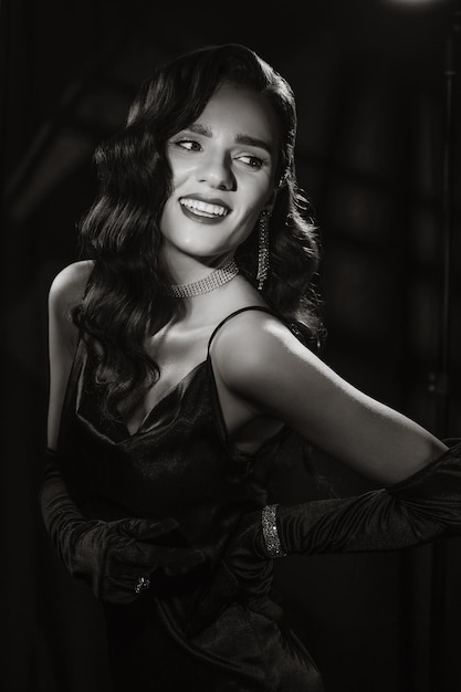 Portrait of elegant woman in vintage retro style of black and white Hollywood film with makeup and hairstyle Brunette girl with jewelry in noir look