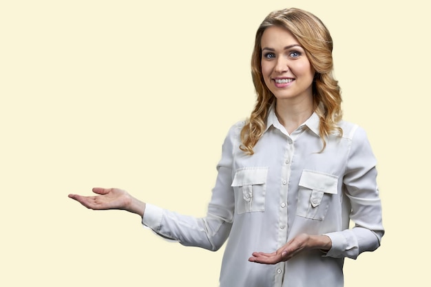 Portrait of elegant young woman showing copy space Isolated on white background