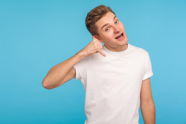 Portrait of emotional young man on blue background