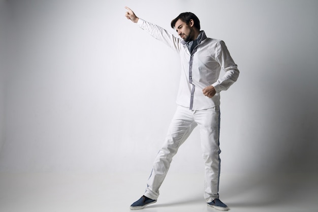 Portrait of an emotional young man wearing white. Isolated over white background.