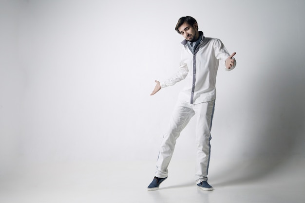 Portrait of an emotional young man wearing white. Isolated over white background.