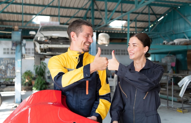 Portrait of engineer and auto mechanic with working on engine repairs in car garages