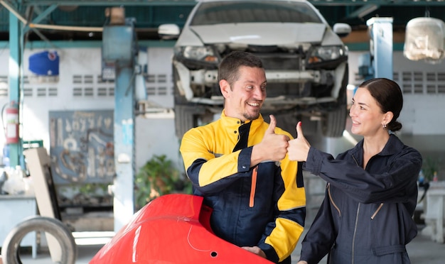 Portrait of engineer and auto mechanic with working on engine repairs in car garages