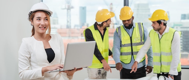 Portrait of engineers facing the camera as they wrap up a group discussion for an architectural