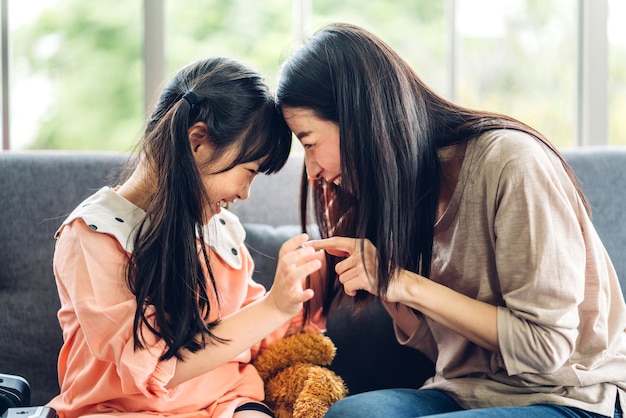 Portrait of enjoy happy love asian family mother and little asian girl child smiling and having fun