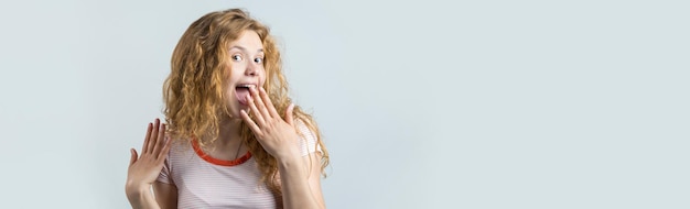 Portrait of an enthusiastic young girl screaming with joy over white background