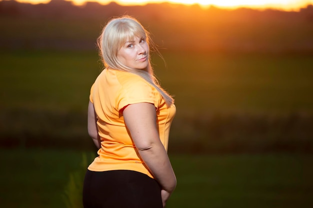 Portrait of a European middleaged woman in a tracksuit posing for the camera