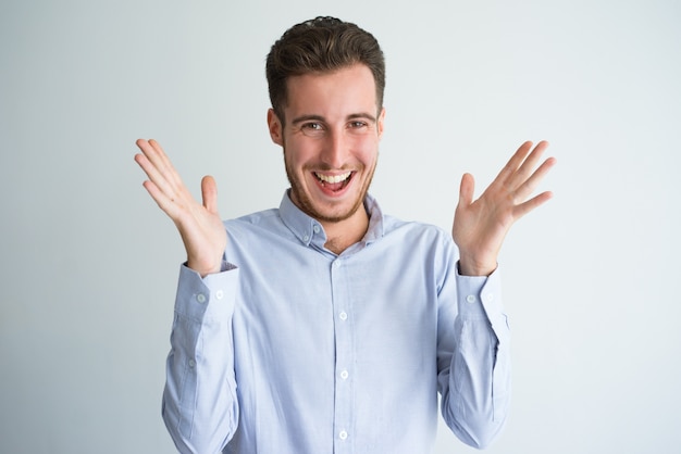 Portrait of excited businessman clapping hands