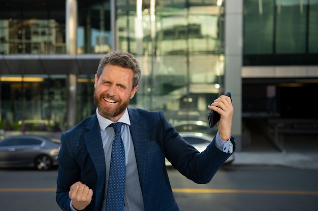 Portrait of excited businessman outdoor successful business