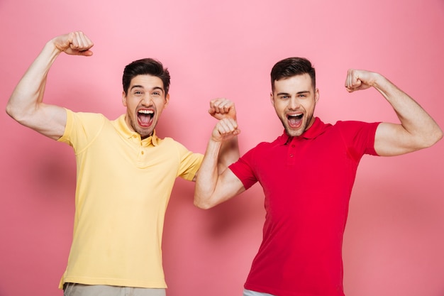 Portrait of an excited friends flexing biceps