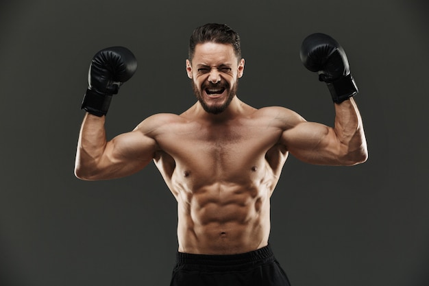 Portrait of an excited muscular sportsman celebrating