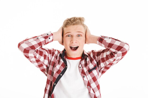 Photo portrait of an excited schoolboy screaming