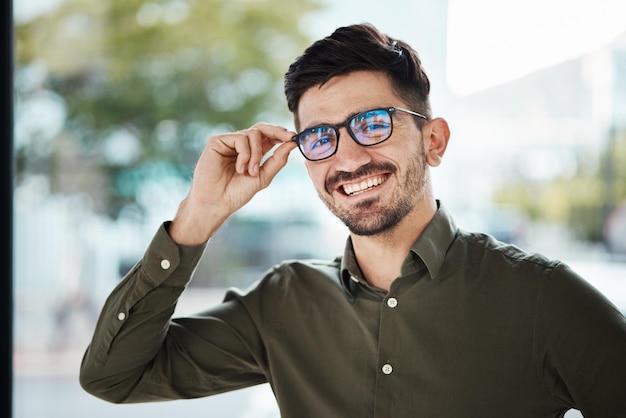 Portrait face of man and happy with glasses for vision eyesight and prescription lens Young male person smile with new frame for designer eyewear optical fashion and assessment in eye care clinic