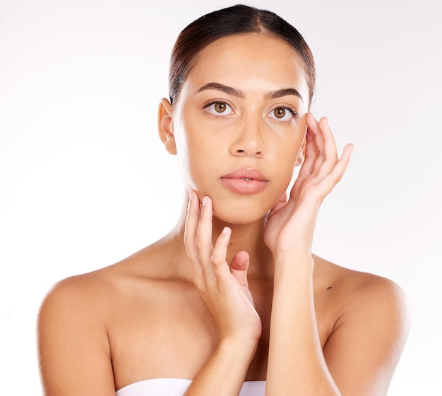 Portrait face and skincare with a model black woman in studio on a gray background for wellness or luxury Makeup cosmetics and hands with an attractive young female touching her natural skin