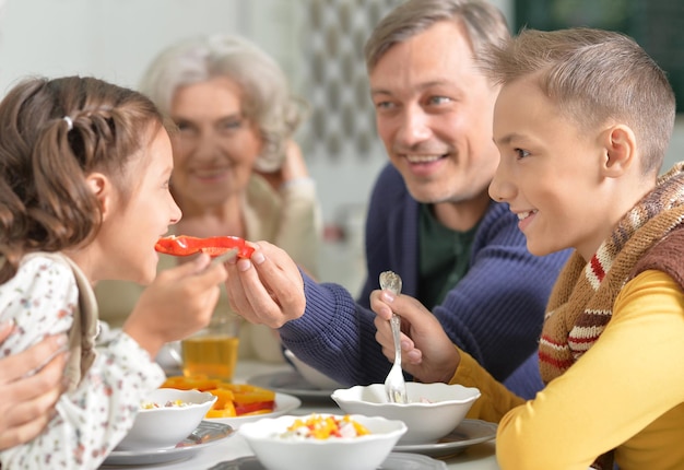 Portrait of a family eating dinner close up