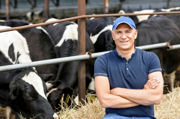 Portrait of a farmer with cows on a ranch