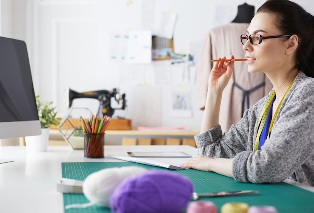 Portrait of Fashion designer working in her studio