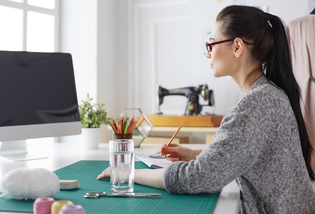 Portrait of Fashion designer working in her studio