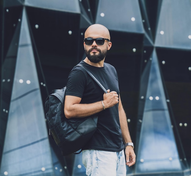 Portrait of a fashion young man at beautiful dark urban background