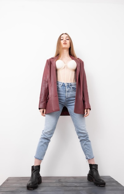 Portrait of a fashionable woman in stylish clothes on a white background