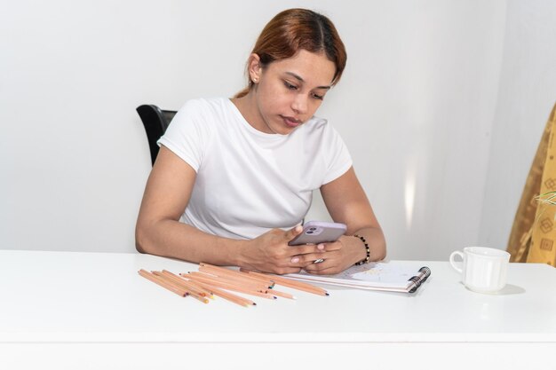 Portrait of female artist drawing at home