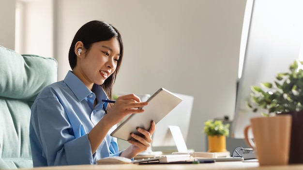 Portrait of female asian designer using tablet