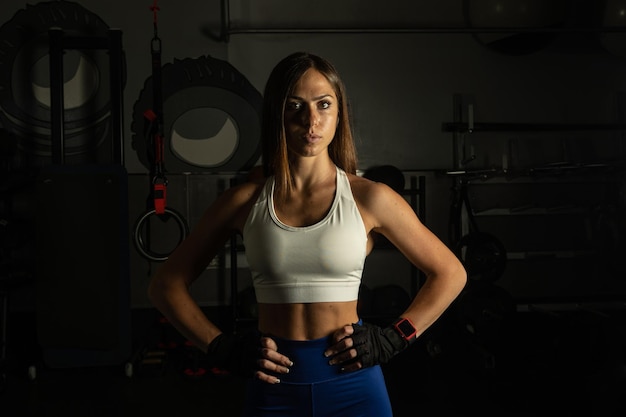 Portrait of female athlete looking at camera in gym