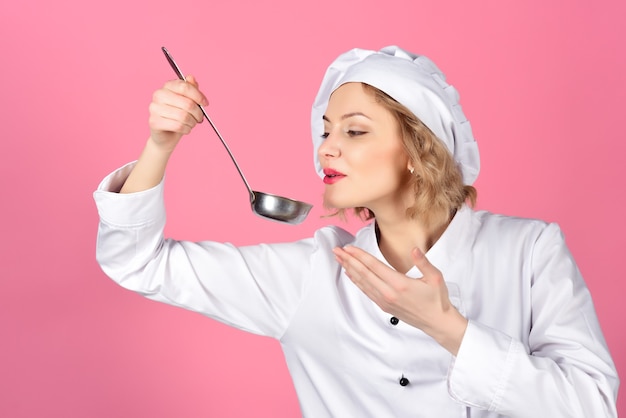 Portrait of female chef holds spoon with hot food cooking and professional culinary concept food