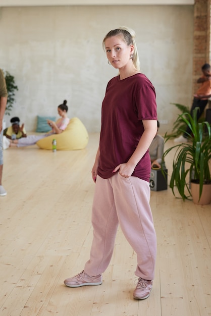 Portrait of female dancer in sports clothing  standing in dance studio