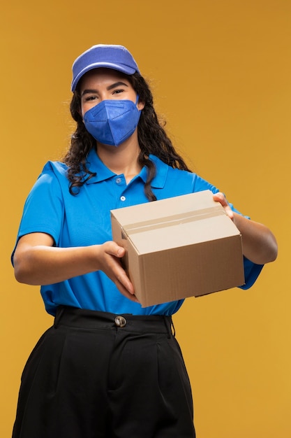 Portrait of female deliverer with medical mask on