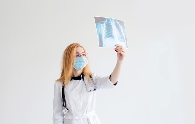 Portrait of a female doctor looking at a chest Xray