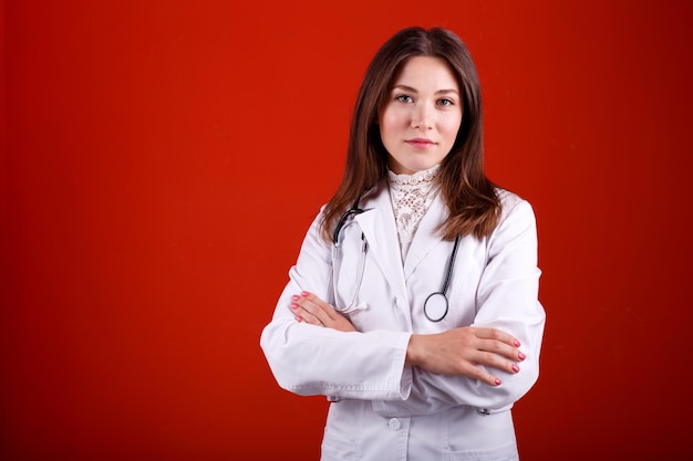 Portrait of a female doctor on a red background