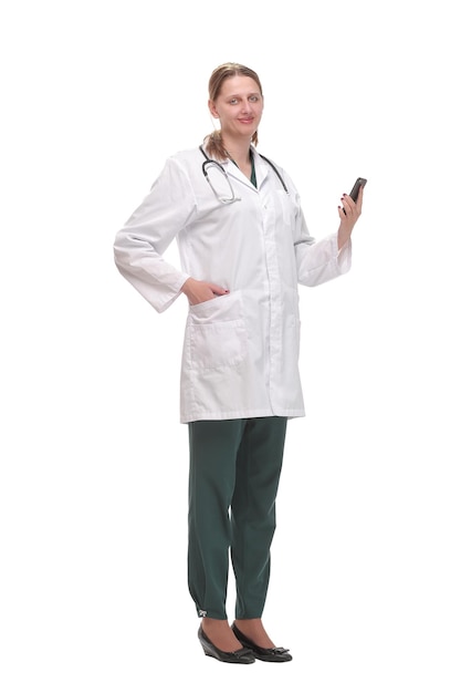 Portrait of female doctor using her mobile phone in the consultation. Isolated over white backbground