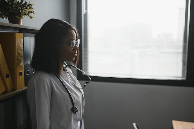 Portrait Of Female Doctor Wearing White Coat In Office