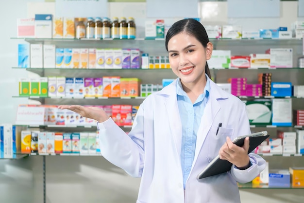 Portrait of female pharmacist using tablet in a modern pharmacy drugstore